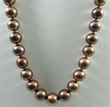 Jewelry Chocolate Tahitian Cultured Pearls
Fabulous "Chocolate" Tahitian Cultured Pearls. Included American International Gemologists (AIG) Pre-Sale Gemological Report reads:
"One graduated single strand cultured pearl necklace seventeen inch princess length, knotted with a 14KT white gold twelve millimeter scalloped plunger style clasp containing thirty-five Tahitian cultured pearls, 10.50mm in size to 13.00 mm in size. The pearls are "Chocolate" color. Exhibiting a medium to high luster, medium to thick nacre, mostly round to off round, lightly spotted with good uniformity.
Chocolate cultured pearls have undergone a treatment
with a pigment altering heat process, or an organic dyeing process that transforms the color into an iridescent chocolate.
Tahitian cultured pearls from in the large "Black Lipped" Pinctada Margaritifera oyster, which is about twice the size of the Japanese Akoya oyster. This warm water species from across the central and South Pacific Ocean is at home in the b