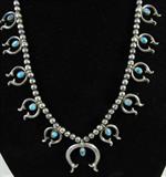 Jewelry Silver Turquoise Naja Symbol Necklace
Stately sterling silver beaded Southwestern style necklace, featuring 11sterling silver Navajo Naja symbols, each with a single turquoise stone in the center. Largest of the symbols is in the center of the necklace. Terminates with a hook style clasp, measures 27.25" long.
From the internet:
"The Naja has its origin with the Moors in Spain. It is a good luck charm to ward off the evil eye. It was often used on the brow-band of Moorish Horses. It is thought that it was handed down from the Spanish Moors to Mexico and then to the Navajo Indians."
Total weight: 2.4 ozt
ZB152