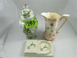 Lot of 3 Vintage Ceramic Pitcher Deco Jar Ash Tray
This lot contains three beautiful ceramic / porcelain pieces. Lot includes:
-Lovely vintage pitcher, pink & white background with several clusters of flowers, many colors and varieties present, gold trim throughout. Numbered on the bottom of the pitcher “LB74”. Measures 9.75” tall, 6” mouth / opening.
-Wonderful antique combination cigarette holder & ash tray, features pictures of mallard ducks in flight, with gold trim. Numbered on the bottom of the tray “639”, measures 9” x 5.5”.
-Gorgeous Asian style ginger jar / urn, white and green floral patterns with gold detailing and borders throughout. Numbered “7614” on the bottom of the jar, measures 13.5” tall including lid.
ZB5104