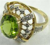 Jewelry 10KT Yellow Gold Peridot & Diamond Ring
Beautiful 10KT yellow gold fashion ring featuring a large, faceted, oval cut, green gemstone, possibly Peridot, decorated with many small, round cut diamonds, in a lovely cutout design. Marked "10KT", ring size: 8.25. Total weight: 2.4 dwt.
ZB1341