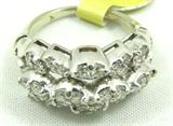 Gorgeous 14kt white gold band featuring several round diamonds in unique setting. Marked "14k", ring size: 3.75. Total weight: 2.9 dwt.
