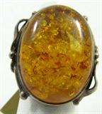 Gorgeous vintage / antique looking sterling silver fashion ring featuring a large Cabochon Amber stone with crackled design. Marked "925", ring size: 7.25. Total weight: .29 ozt.