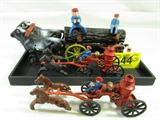 Lot of 3 cast iron toys including:
- Log pulling wagon, pulled by 2 oxen, with a passenger and a driver, both removable. On a brown and green trailer, reins are missing but easily replaceable. Driver is in two pieces held together by a rubber band, repair with super glue. Measures 14" long x 6" tall including driver.
- Two (2) miniature fire wagons / engines, each is pulled by two brown horses, with a driver and water tower. Drivers are attached to the seats, not removable. Each measures 9" long x 3.5" tall including water tower.