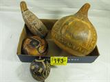 Lot of 4 Peruvian Hand Carved Gourds 1 Signed
This lot contains 4 beautifully hand carved and dyed gourds which appear to be Peruvian. Lot includes:
- An open jug featuring one elephant and 4 rhinoceros figures carved into the outer surface. Measures approximately 12" tall with a 34" circumference.
- A closed gourd which could be used as a rattle or maraca. Outer surface has bird and lizard carvings on it.
Measures about 6" long with a 13" circumference.
- A closed gourd which could be used as a rattle or maraca. Outer surface has intricate carvings of a man following a path through mountains, and valleys, past houses, animals and other people. The end of the path is filled with musicians and dancers who appear to be celebrating a special occasion. Measures approximately 11" long with a 13" circumference.
- A round gourd, flat on both sides, with an amazing carving of some kind of cat. Signed "E Medina".
Measures 6.5" tall with a 17" circumference.