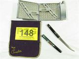 Mixed Lot Cigarette Case & Japanese Knife
This lot contains:
- A small sword shaped fixed blade knife with a wooden handle and sheath. The blade is marked "Japan". The handle and sheath appear to be hand painted. Measures 6.5" long.
- A silver color cigarette holder and combination lighter. Made by Royal Case Light. Measures 4.5" x 3".