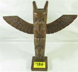 Alaska Wooden Carved Totem Raven Bear Human Signed
This lot contains a wonderful wooden carving of an Alaskan totem pole. Features a raven / bird figure at the top of the totem pole, wings spread, with a bear face in the middle, and a seemingly human figure at the bottom of the pole. Exquisite details, signed on the bottom: "By Kiana of Alaska". In Alaskan / Tlingit mythology, the bear and the raven are significant deities & symbols. The Raven is a trickster god who brings gifts to the people, and the Bear is thought to be a kindred soul with humans. In Tlingit culture, the totem pole often represents a family crest.
Measures: 17.75"tall with the wingspan measuring 17.25" across.