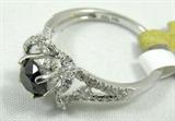 Jewelry 18KT White Gold Black Diamond Ring
Beautiful 18KT white gold & diamond ring, size: 7. Included Gemological Laboratory of America (GLA) premium appraisal reads:
"One lady's polished, stamped and electronically tested solid 18k white gold ring mounted with: 1 Genuine Round Black Diamond and 50 Genuine Round Single Diamonds. This item weighs 2.82 grams and fits a finger size 7.00. The setting measures 8.50 x 10.36 mm and the band measures 3.41 mm tapering down to 1.71 mm at the center of the shank. The condition is BRAND NEW. The gemstones have been analyzed in the mounting.
MAIN GEMSTONE:
Identity: Genuine Black Diamond
Cut: Round (faceted)
Measurements: 5.31-3.90mm
Quantity: 1
Carat Weight: 0.80 ct (est)
Clarity Grade: Opaque
Color Grade: Black
ADJACENT GEMSTONE:
Identity: Genuine Diamond
Cut: Round single (faceted)
Measurements: 1.50-1.00 mm (no depth) (range)
Quantity: 50
Carat Weight: 0.27 ctw (est)
Clarity Weight: SI- 2/I-1
Color Grade: G-H
Cut Grade: 5-Good
Diamond carat