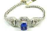 Jewelry 14KT White Gold Tanzanite Bracelet*
Stunning 14KT white gold & Tanzanite diamond bracelet. Included American International Gemologists (AIG) Pre-Sale Estimated Retail & Gemological Report reads:
"One electronically tested 14KT white gold ladies cast and assembled tanzanite and diamond bracelet. The six and one half inch length strap tapers from thirteen millimeters to three millimeters. Bright polish finish with milgrain detailing throughout. Identified with markings of "14K". Condition is new, good workmanship.
Reminiscent of the jewelry designs from the Art Deco Period. The Paris Exposition of Decorative Arts and Modern Manufacturers in 1925 gave the movement its name. Bold geometric designs & cubism, where emphasized Identified with markings of "14K" Containing:
one prong set rectangular cushion cut natural Tanzanite, measuring 9.00 x 6.50 x 4.90mm, approximate weight of 2.43ct., clarity is eye clean, type
I, medium dark, moderately strong, violetish blue color, (GIA vB 6/4)