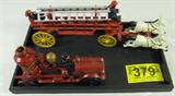Cast Iron Horse Drawn Toy Fire Wagon
A cast iron toy fire wagon being pulled by three horses. The wagon is red and black and has an eagle figurine in front of the water tower. One fireman stands on the back of the wagon and one sits in the driver's seat. Measures 8" tall x 21.5" long.