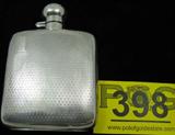 ntique Sterling Silver Beverage Flask Signed "HH"
This lot features a wonderful sterling silver beverage flask with a series of hallmarks, including "HH", possibly a British hallmark. Also bears the insignia of a lion, signifying its sterling silver quality. Other undetermined markings present. The flask features an embossed / textured style design on the front and back with smooth silver sides and cap. Inside of the cap is corked. Measures 5" tall x 3.75" wide.
Total weight: 3.70 ozt