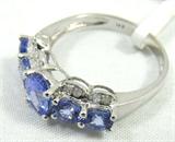 Jewelry 14kt White Gold Tanzanite Ring
Beautiful 14kt white gold fashion ring featuring an oval cut, prong set, faceted Tanzanite stone, with four surrounding circle cut Tanzanite stones accented with small diamonds. Marked "14k", ring size: 7. Total weight: 1.7 dwt.