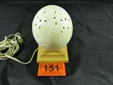 Carved Ostrich Egg Lamp Made In Africa Signed
An authentic ostrich egg that has been hollowed and hand carved on the outer surface which features a lion. Paper label on the egg reads "Made In South Africa". Hand signed "Rauka Ckuene". Egg shell is mounted to a resin base. Would make a nice night light. Measures approximately 6.5" tall with a 15" circumference.