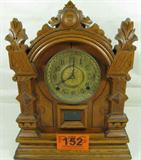 William Gilbert Excelsior Parlor / Mantle Clock
A fantastic Excelsior L shelf / mantle clock manufactured by the William L. Gilbert Clock Company. This clock has a beautifully carved oak cabinet. There is a small crack in the wood just below the right corner of the pendulum window. The wind up clock has a gold face with black hands. The door to the back opening appears to have been replaced. Working condition is unknown but the chime has a loud clear tone when the hands are moved to the hour and half hour. The pendulum is included but no winding key. Measures 16.5" tall x 13" across x 6" in depth.