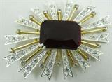 Jewelry Kenneth Jay Lane Rhinestone Brooch Signed
A stunning sun burst shaped brooch, signed "KJL". The brooch features sparking clear rhinestones and a large emerald cut red center stone. Measures 3" across.