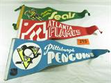 Lot of 3 National Hockey League Pennants
Attention hockey memorabilia collectors, you'll want to add these felt pennants to your collection. Each one of these vintage flags shows signs of wear from age and use. Each one measures approximately 28" long. This lot includes:
- Pittsburg Penquins.
- Atlanta Flames.
- California Golden Seals.