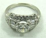 Jewelry Platinum & Diamond Cocktail Ring*
Gorgeous platinum and diamond cocktail ring with vintage design. Included Labtrade Gemological Laboratory report reads: "One Platinum lady's ring stamped "Paladium". Containing: One round brilliant cut diamond approximate weight of 0.90cts. Clarity VS-1 Color H. Thirty-Two baguette and round single cut diamonds approximate total weight of 0.60cts. Clarity VS1-VS2 color G-H. Total weight of ring 3.44gm". Ring