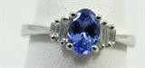 Jewelry 14kt White Gold Tanzanite Ring
Beautiful 14kt white gold fashion ring featuring an oval shaped, prong set, faceted Tanzanite stone and baguette cut diamond stones in graduated tier design. Marked "14k", ring size: 7. Total weight: 1.5 dwt.