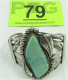 Jewelry Sterling & Turquoise Cuff Bracelet
A fabulous Native American Indian designed cuff bracelet featuring a split band and a large greenish turquoise setting. Stone is surrounded by a rope design with silver bead and feather accents. Measures 5" with a 1.5" opening.
Total weight: 2.89 ozt