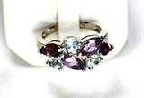 Jewelry 18kt White Gold Amethyst and Topaz Ring
Gorgeous 18kt white gold fashion ring featuring prong set amethyst and blue topaz stones. Included Labtrade Gemological Laboratory report reads: "One stamped 18kt white gold lady's ring. Containing: Seven marquis and round cut natural amethysts and blue topaz, approximate total weight of 2.50cts. Weight of ring 6.89 gm". Band marked "Feraud", ring size: 6.5, total weight: 4.4 dwt.