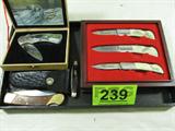 Mixed Lot Pocket / Folding Knives Winchester & Moe
This lot includes the following knives:
- A Winchester 2006 limited edition boxed set of 3 folding knives. A hunter or fisher's delight and an ideal gift for Christmas. Each knife has a stainless steel blade and the ivory-like handles each depict a different hunting or fishing scene. Each knife is approx 6" long.
- A single blade buck knife with a brass and wood handle. Comes with a black leather case with belt loops. Measures approximately 9" long.
- A Schrade 855 3 blade pocket knife. Measures 3.25" long with the blades closed. Shows signs of wear from age and use.
- A folding knife, the handle features an image of a bear standing in a river. The blade is marked "Made in China". Knife is presented in its original display case. The knife measures 4" long in the closed position.