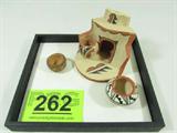 Lot of 3 Jemez Miniature Pottery Signed
This lot includes three pieces of miniature Native American Indian pottery:
- A bowl with black and white geometric designs, Measures 1.5" tall. Signed "M. Toya - Jemez". Piece has a small chip on the inner rim.
- A bowl with brown decorations. Measures .75" tall. Free of chips and cracks. Signed "AY - Jemez".
- A figurative incense burner with brown and black decorations. Measures 3.25" tall. Signed "L. Lucero - Jemez". Has a small chip on the front.