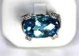 Jewelry 14kt White Gold Blue Topaz Ring
Beautiful 14kt white gold fashion ring featuring a large oval shaped blue topaz stone. Included Labtrade Gemological Laboratory report reads: "One tested 14kt white gold lady's ring. Containing: One oval checkerboard cut natural blue topaz approximate weight of 10.00cts. Sixty-two round brilliant cut diamonds approximate total weight of 0.36cts. Clarity VS-1 to SI-1 Color HI. Total weight of ring 11.05gm". Ring size: 4.5, total weight: 7.0 dwt.