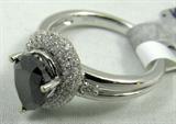 Jewelry 18K White Gold Black Diamond Ring
Gorgeous 18KT white gold & black diamond ladies ring,size 6.25. Included American International Gemologists (AIG) Report reads:
"One electronically tested 18KT white gold ladies cast diamond ring with a bright polish finis. Condition is new, good workmanship. The featured fancy black diamond is set within a diamond bezel, supported by split shoulders and completed by a two and one-half millimeter wide band. Trademark is HANA. Identified with markings of "18K". Containing:
One prong set pear shaped cut diamond, measuring 8.89 x 6.52 x 4.10mm exact weight 1.82ct. Transmitting light very diffusely, opaque. Naturally occurring internal & external characteristics are present. Graded loose prior to setting in the GIA Laboratory, Report # 5141321993.
Color: Fancy black, irradiated
Depth: 62.9%
Table: 56.8%
One hundred twenty-two pave & prong set round brilliant cut diamonds, measuring 1.90 - 0.90 x 0.84mm (depth est) approximate total weight of 122 st