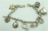 Jewelry Sterling Silver Charm Bracelet
Lovely sterling silver rolo style chain bracelet featuring several darling figural charms, including: Wedding rings, high heel shoe, purse, elephant and more! Marked "925", measures: 7.5" long. Total weight: .95 ozt.