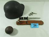 Swiss Helmet, Cannon Ball, Knife, & Pistol Frame
- Swiss M18 Army Helmet. Seeing service in both WWI and WWII, is the first steel helmet issued to Swiss troops during WWI and marked a great advancement in military headgear. Originally painted olive, these helmets were recalled and modified in 1944.
Features include: Made of steel, Excellent condition with original leather liner, Adjustable chinstrap, and Rough texture finish to prevent glare This is a great chance to own a piece of history.
- Cannon ball of unknown origin
- Knife with 7" blade, leather sheath, and stamped USA 1944.
- Pistol of unknown maker, caliber, etc. Missing grips.