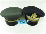 Two US Army Officer Dress Uniform Hats. One is a officer dress green hat with does not include the USA brass insignia. One is an Infantry officer dress blue hat which includes the USA brass insignia. The name is LT Chas D. Archbold. Both hats are in good condition.
