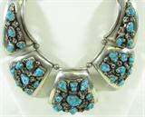 Large Sterling Silver Turquoise Necklace
Fabulous large beaded sterling silver Southwestern style necklace featuring several turquoise nugget stones. This piece is signed and marked "AC Sterling", measures: 15" long. Total weight: 5.47 ozt.