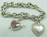 Sterling Silver Judith Ripka Bracelet
Gorgeous sterling silver Judith Ripka charm bracelet with 2 heart shaped charms. One charm is decorated with red colored gemstones and an arrow design. Marked "Judith Ripka 925", bracelet measures: 7.25" long. Total weight: 1.93 ozt.