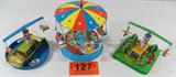 Lot of 3 Tin Litho Carnival Swing Carousels
This lot contains three vintage reproduction tin litho wind-up carnival toys:
- A colorful swing type carousel with 8 passengers in four gondola style cars. Wind up lever appears to be in good working condition. Measures 6.5" tall x 5.75" in diameter. Made in China.
- A double swing toy with tiny airplanes suspended from the top bar. Center appears to be a lighthouse. Measures 3.75" tall. Base is 4.75" x 4.75".
- A double swing toy with an airplane on one side and a blimp / dirigible airship on the other. Each is suspended from a bar which sits atop a lighthouse. Measures 4" tall with a 5.25" diameter.