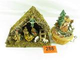 Lot of 2 Anri Thorsen Music Box & Italy Manger
This lot includes the following vintage items made in Italy:
- A music box made by Anri in Italy with Swiss movement by Thorens. Features a little boy and girl surrounded by wildlife and dancing back to back. Plays the tune "Emperor's Waltz". Musical movement works well. One of the the deer on the top is missing an ear. Measures 8.5" tall with a 6.5" diameter.
- A wood and moss stable featuring a Manger scene with Mary, Joseph, baby Jesus, two sheep, one King, and an angel. All figures are made of a hard plastic resin. Bottom of stable is stamped "Made in Italy". The baby Jesus' bed is stamped on the bottom, "Italy 100/2C". Measures 8.5" tall x 12" across x 6.5" deep.