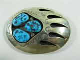 Jewelry Large Bear Claw Sterling Silver Buckle
Large sterling silver oval shaped belt buckle with pierced bear paw / claw design. Decorated with three large turquoise nugget stones. Beautiful workmanship! Marked / signed "TG sterling", measures: 3.75" wide. Total weig
