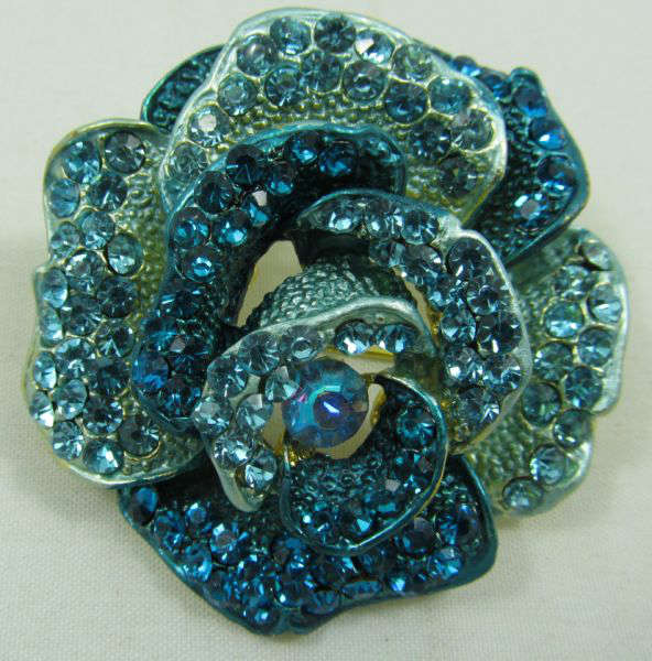 Jewelry Blue Rhinestone Rose Brooch / Pin
Gorgeous rose shaped brooch / pin covered in several sparkly blue rhinestones. Measures: 2" diameter.