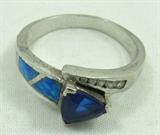 Jewelry Sterling Silver Opal & Sapphire Ring
Gorgeous sterling silver fashion ring featuring inlaid opal stones, clear gemstones and a blue colored stone, possibly a blue sapphire. Main stone shows signs of wear. Marked "925", ring size: 9. Total weight: .14 ozt.