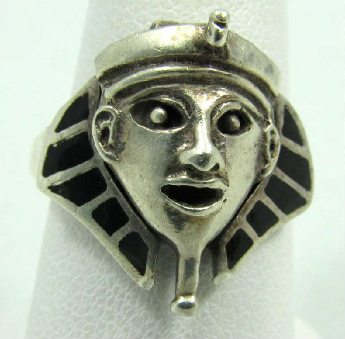 Jewelry Sterling Silver Pharaoh Fashion Ring
Awesome sterling silver fashion ring shaped like a Pharaoh with inlaid onyx stones. The face of the Pharaoh is hinged and reveals a snuff compartment. Marked "925", ring size: 8.75. Total weight: .18 ozt.