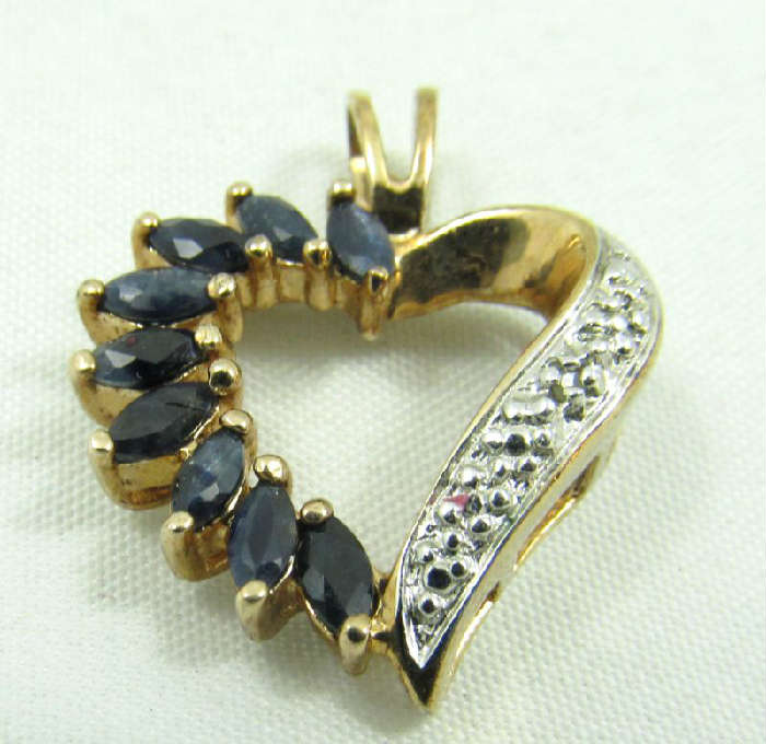 Jewelry Gold Washed Sterling Heart Pendant
Gorgeous gold washed sterling silver fashion heart shaped pendant featuring marquis shaped blue stones, possibly sapphires. Marked "925", measures: 1" long. Total weight: .08 ozt.