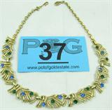 Jewelry Gold Toned Rhinestone Choker Necklace
Lovely gold toned choker / collar style vintage costume necklace featuring blue and green colored rhinestones. Unknown age and maker, measures: 16" long.