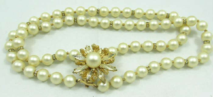 Jewelry Vintage Faux Pearl Double Strand Necklace
Lovely vintage faux pearl beaded double strand necklace with rhinestone flower shaped pendant. Measures: 16.25" long.