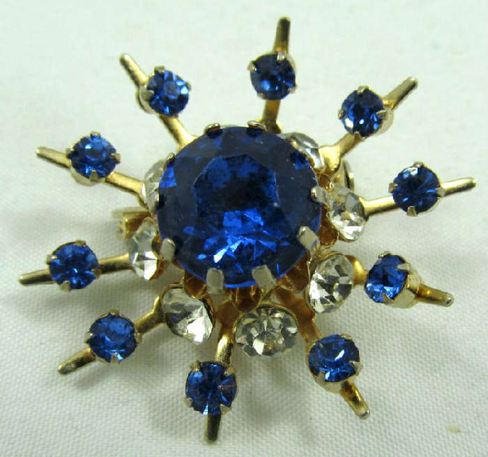 Jewelry Vintage Coro Snowflake Brooch / Pin
Lovely vintage Coro snowflake / sunburst shaped brooch accented with clear and blue colored rhinestones. Marked "Coro", measures: 1.5" diameter.