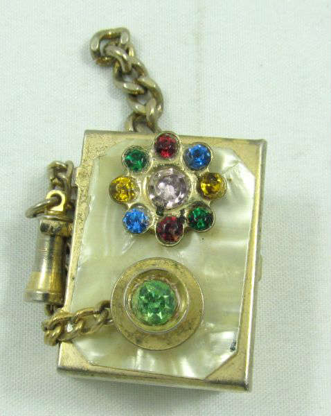 Jewelry Gold Toned Rhinestone Phone Charm
Darling vintage charm / pendant shaped like an old kellog style phone decorated with rhinestones. Measures: 1.25" long.