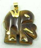 Jewelry Tiger Eye Elephant Necklace Pendant
Darling elephant shaped Tiger Eye pendant with gold toned accents. Unknown maker and age, measures: 1.25" tall.