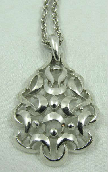 Jewelry Trifari Silver Tone Costume Necklace
Beautiful silver toned costume necklace and pendant made by Trifari. Pendant has lovely tear drop shaped filigree design. Measures: 20" long, marked "Trifari".