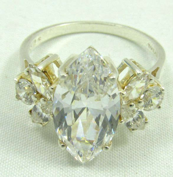 Jewelry Sterling Silver CZ Cocktail Ring
Beautiful sterling silver fashion ring featuring large sparkly Cubic Zirconia stones. Marked "925", ring size: 11. Total weight: .21 ozt.