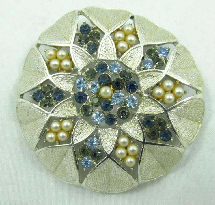 Jewelry Vintage Coro Faux Pearl Rhinestone Brooch
Beautiful vintage silver toned brooch accented with blue rhinestones and faux pearls. Marked "Coro", measures: 2" diameter.