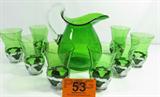 Lot#: 53
Description: Emerald Farber Bros Krome Kraft Cambridge Decanter
Extraordinary vintage 1930's period Art Deco style pitcher and glass set. From Cambridge Glass Co., together with Farber Brothers-Krome Kraft, these gorgeous Doulton No. 3400/141 emerald green colored hand blown glass inserts snap into place, are interchangeable and complimented by the bright chrome silver Farberware metal stems. Pieces are marked “Farber Bros, NYC Pat. No. 87496-1924011”. Lot features:
- Large oblong shaped pitcher / jug with applied clear glass handle. Measures 9" tall to the top of the handle x 6" in diameter.
- 8 tall water tumblers / ice tea glasses with Farber chrome metal stems. Two have a tiny flea bite in the rim and a dent in the metal stem. Measures 5" tall x 3.25" in diameter at the top.
Tag words: depression glass, margarita set
