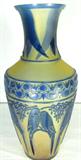 Lot#: 356
Description: Vintage Kelsey Pilgrim Cameo Glass Vase, Love Bird
Exquisite piece of hand carved Pilgrim cameo glass by famed glass artist Kelsey Murphy. Kelsey Murphy and Robert Bomkamp joined forces with now extinct Pilgrim Glass in 1987. Created on a multi-layered piece of Pilgrim's cobalt blue overlay and carved back to a frosted amber / tan background. Elaborate scrolled figural leaves and love birds wrap around the entire circumference with special attention in the intricate detailing in the delicate ribbon border. This is truly a stunning piece of Art Glass, there is no front or back, it can be displayed from any angle. Signed on the bottom “Kelsey Pilgrim, 2nd Ed. 250 pcs. 900752, 1993”. In perfect condition with no chips, cracks or repairs. The original manufacturing facility in West Virginia is no longer in existence and these pieces have become more difficult to find even though the original artist have continue to teach and produce new pieces. Measures 13.25" tall x