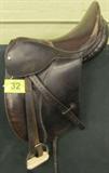Lot#: 32
Description: Vintage English Leather Dressage Saddle, Equine
Vintage dark brown leather English dressage horseback riding / jumping saddle manufactured by Kiln Saddlery, Colchester, England. It comes complete with white brass metal stirrups, and is equipped with spring tree construction in the seat. It features gently padded knee rolls, longer straight cut flaps, deep seat and long billets. The saddle looks to be in excellent shape with minimal wear and looks well taken care of and conditioned. It is embossed "Made in England" and "Spring Tree" under the flap and has 2 riveted brass plaques under the pommel flap which read "Made in England, Kiln Saddlery Ltd., Colchester, England". Seat measures about 17" long, flap measures 17.5” tall.
Tag words: tack equipment, equine, horse, pony
For similar items see lot # 392
ZB152 EAK